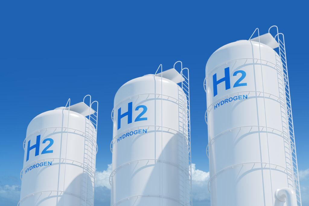 Three hydrogen energy tanks against a blue sky.