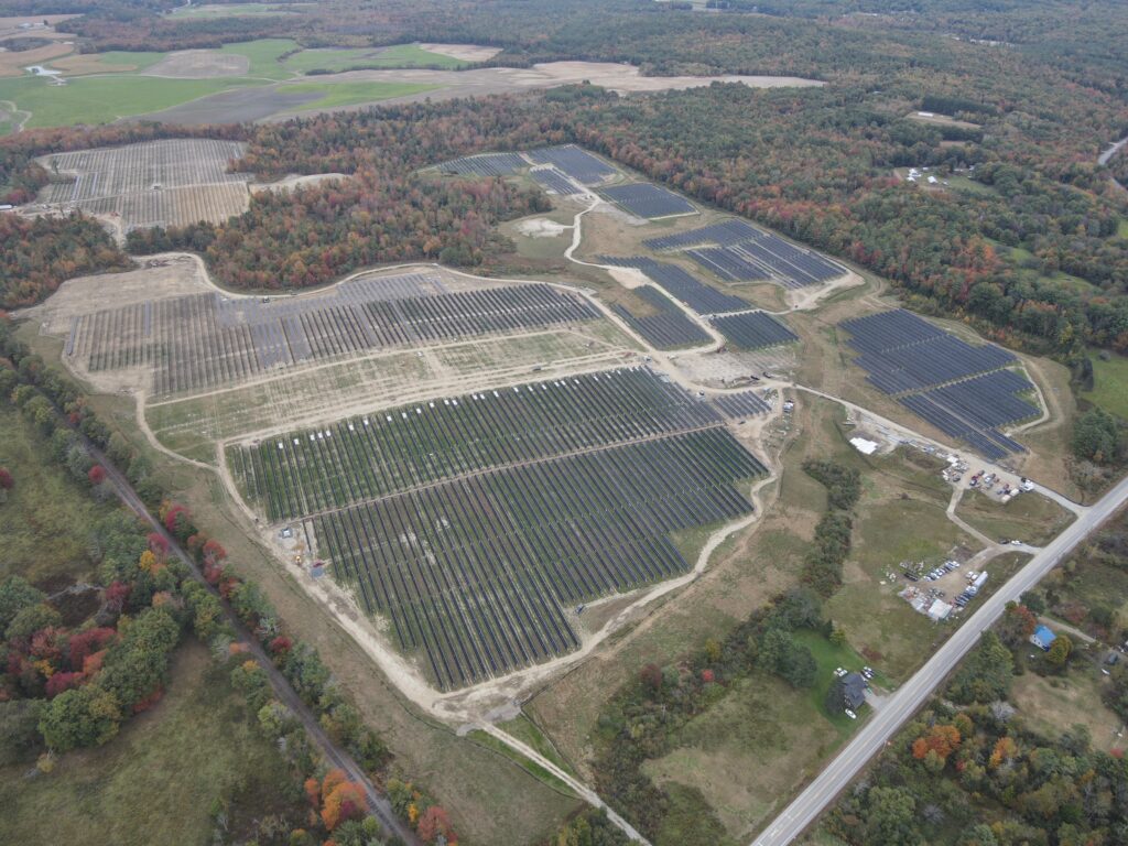 Aerial shot of a utility scale solar project with several arrays.